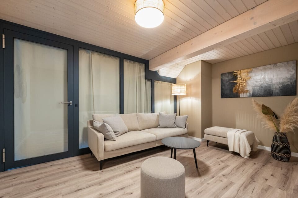 Enjoy a beautifully designed lounge space with soft lighting and calming tones, offering both openness and privacy. Perfect for relaxing evenings, movie nights, or peaceful rest.
