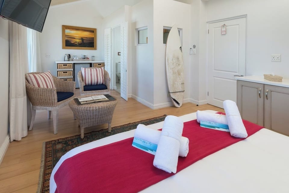 Deluxe Double Room, Beach View | Minibar, in-room safe, laptop workspace, blackout drapes