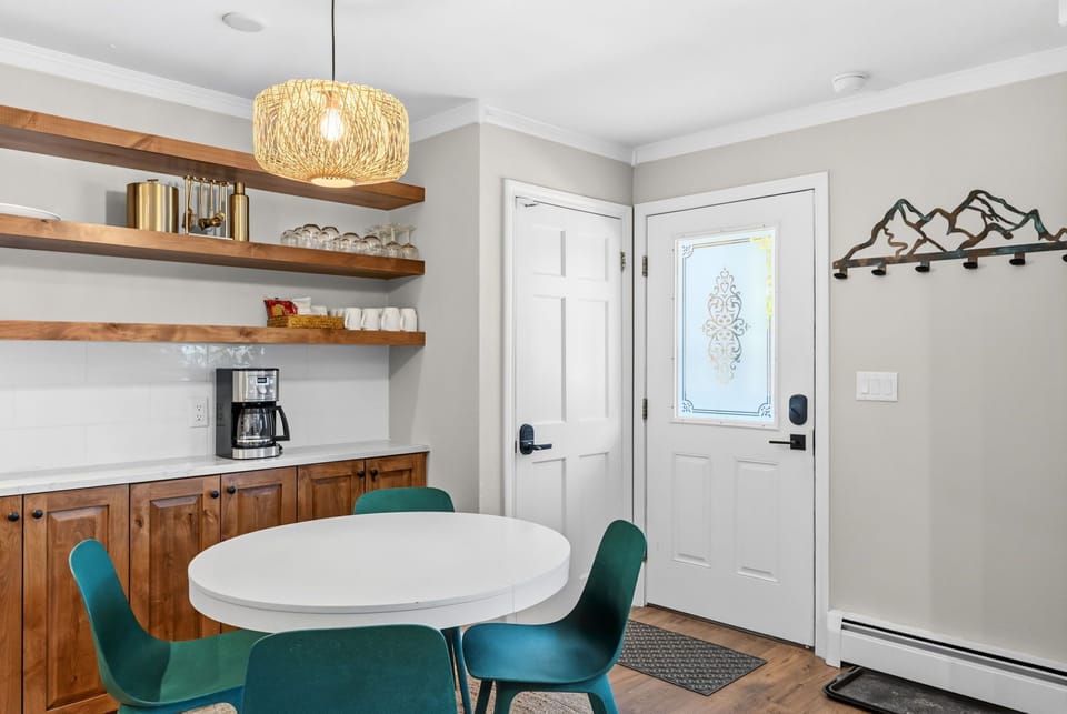 Step into your bright, welcoming entry with a cozy dining nook and coffee station ready to start your mornings. Natural light and mountain-inspired decor create a warm, inviting atmosphere for your getaway.