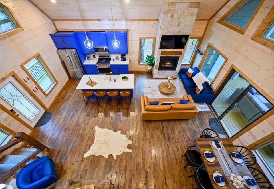From above, the open-concept layout showcases the spacious living area, dining space, and kitchen designed for easy gathering and connection.