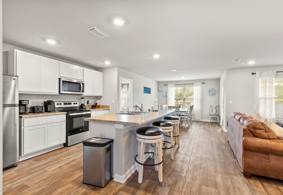 Fully stocked modern kitchen with stainless steel appliances, perfect for preparing seaside feasts.