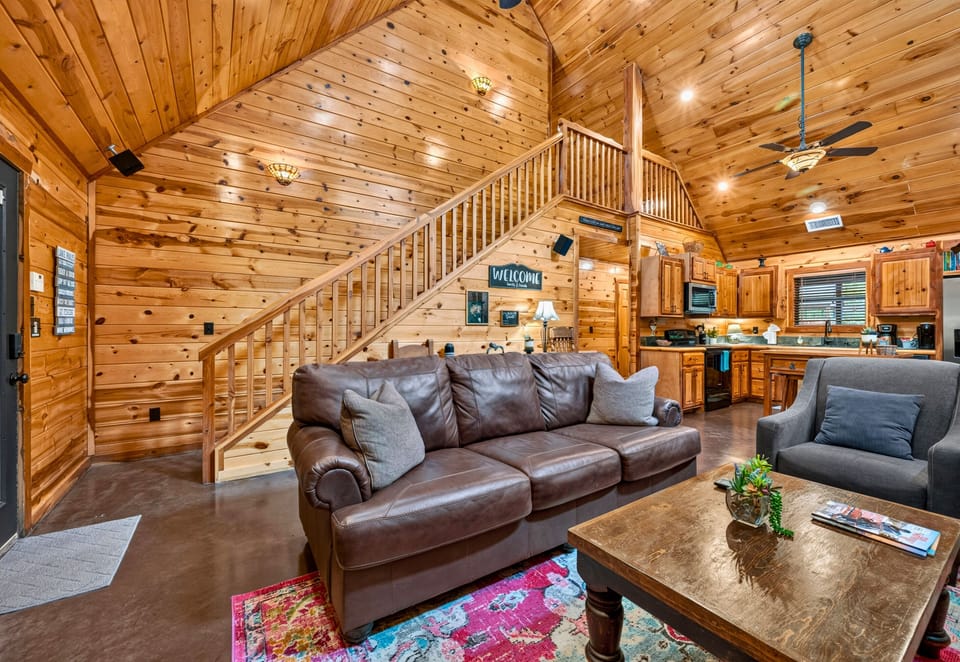 Vaulted ceilings, a soaring stone fireplace, and comfortable seating create an inviting living space that's perfect for gathering together after a day of adventure.