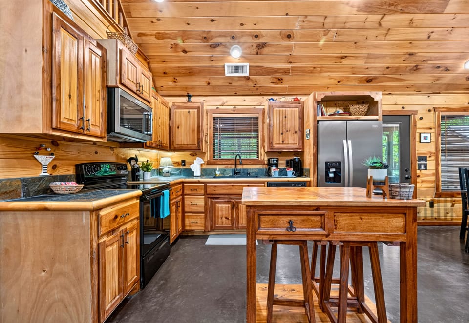 With generous counter space, bar seating, and everything you need close at hand, the kitchen is ready for everything from quick breakfasts to family dinners.