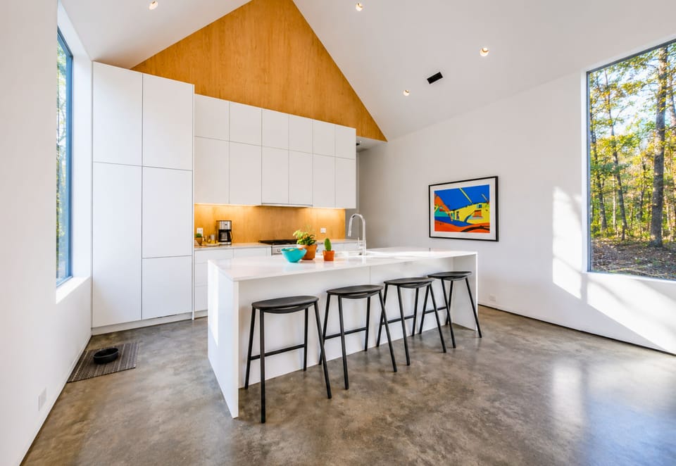 The sleek kitchen combines modern finishes with plenty of space for preparing everything from quick breakfasts to family dinners.
