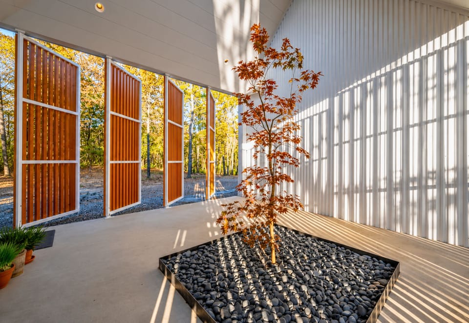 This area brings the outside in, filling the home with sunlight and showcasing the wooded landscape from every angle.