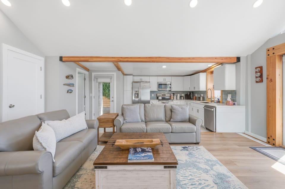 Relax in your bright, open living space where rustic wood beams meet modern comfort. Sink into plush seating, whip up meals in your fully-equipped kitchen, and enjoy the airy flow of this beautifully designed retreat.