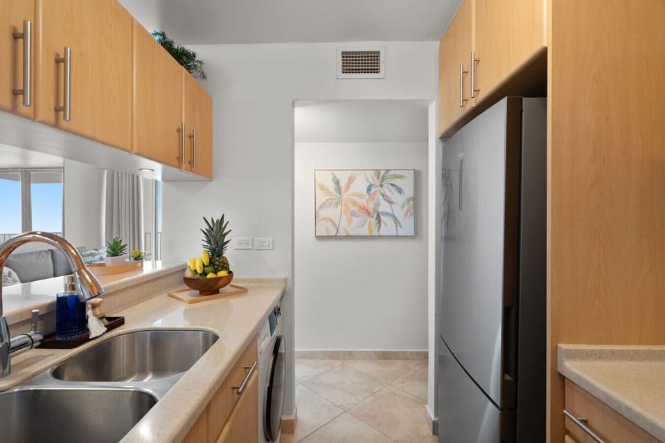 Open kitchen with coastal décor and ocean views reflected throughout.
