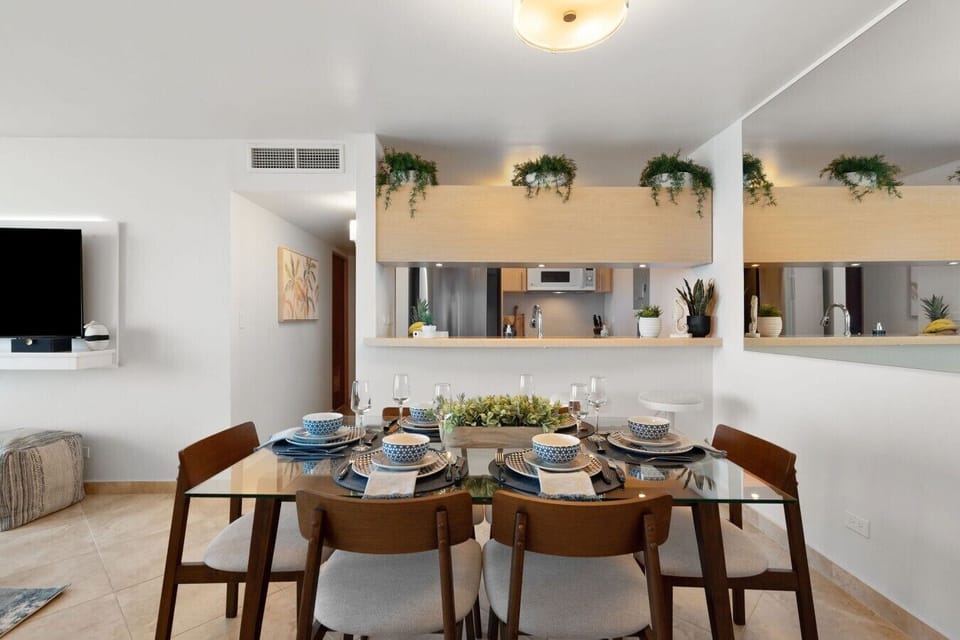 Dining area and open kitchen with coastal décor and ocean views reflected throughout