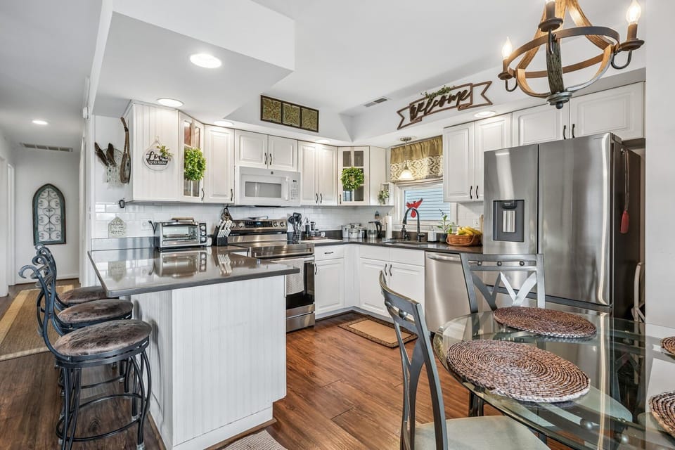 Picture yourself preparing your favorite meals in this bright, fully equipped kitchen with modern appliances, stylish seating, and all the comforts of home.