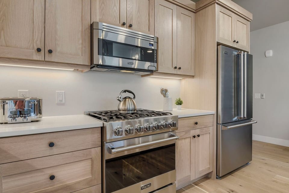 Your fully-equipped kitchen features premium appliances and warm wood cabinetry, ready to help you whip up quick breakfasts or leisurely dinners during your stay.