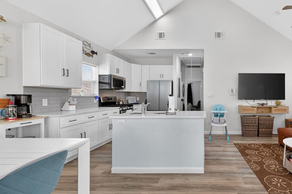 Spacious kitchen flows into bright open living space.