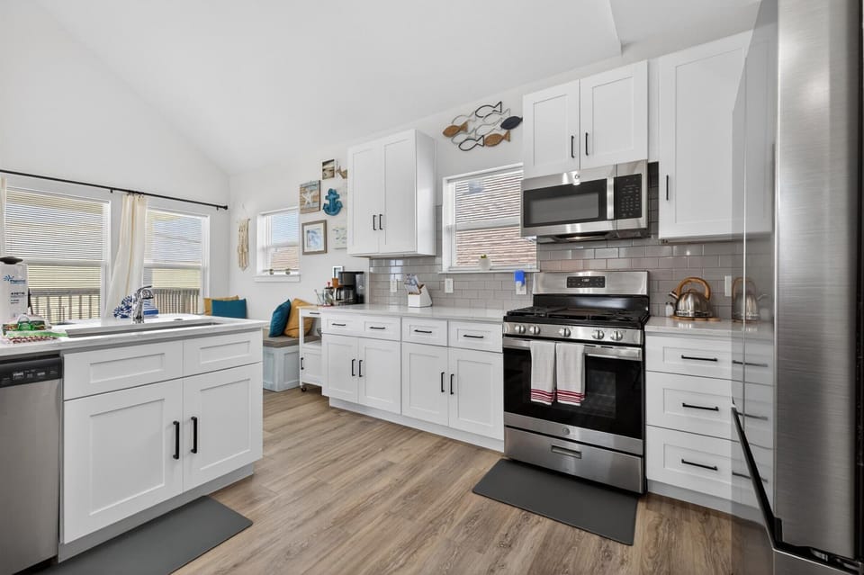 Bright kitchen with stainless appliances and cozy nook.