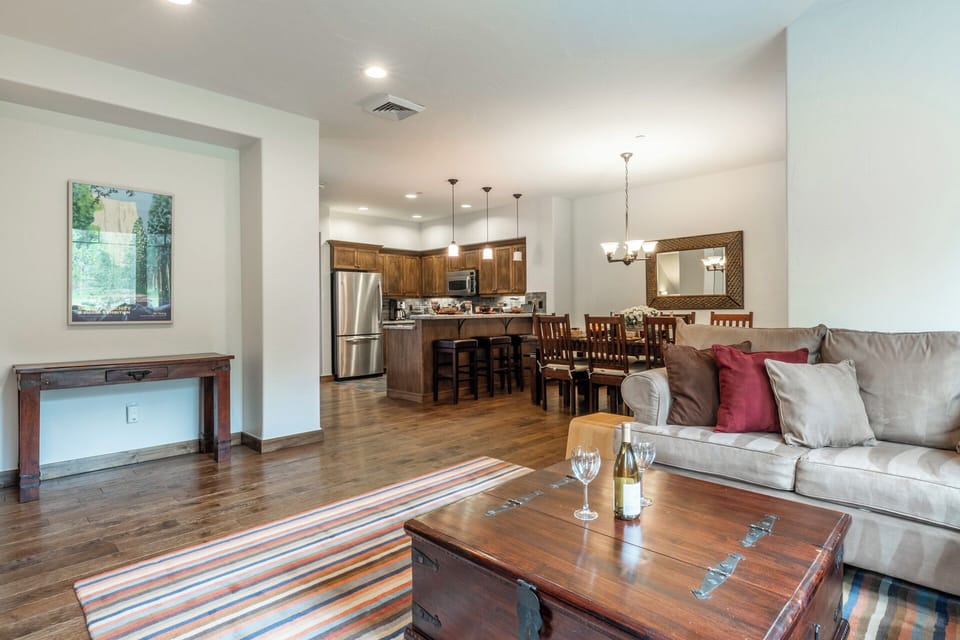 Unwind in this open, airy living space where rich wood tones and plush seating invite you to relax after a day of adventure. The fully equipped kitchen beckons for home-cooked meals.