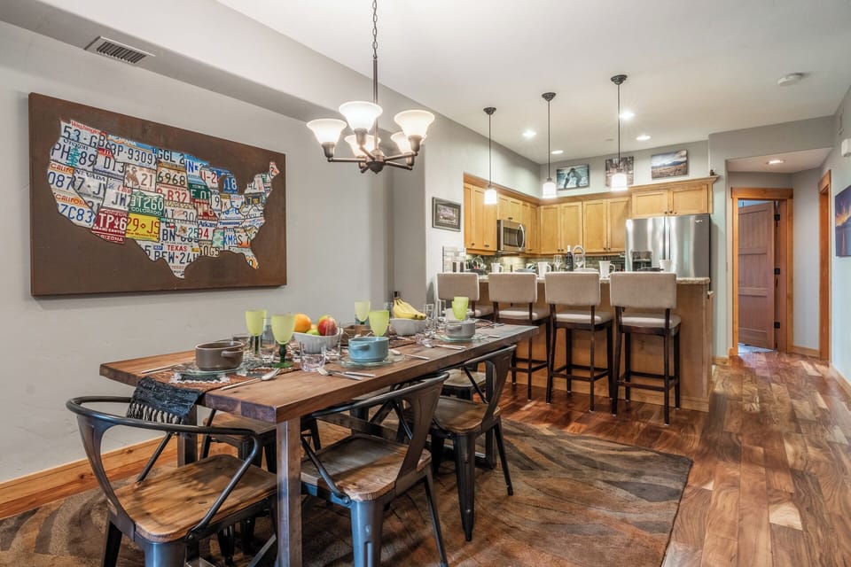 Gather around the spacious dining table where your mornings start with fresh coffee and your evenings with shared meals and laughter beneath warm pendant lighting.