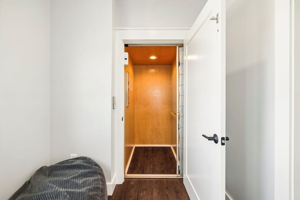 A modern elevator with warm wood-grain interior provides easy access throughout your stay, ensuring effortless movement between floors with style and convenience.