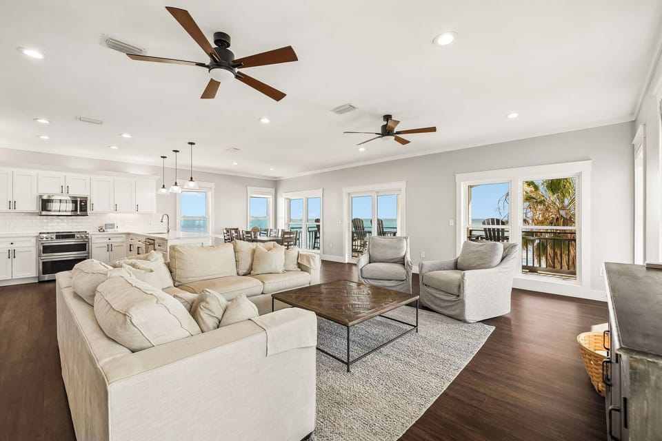 Sink into plush seating as coastal breezes drift through your open-concept living space, where sunlight and ocean views fill every corner with warmth and tranquility.