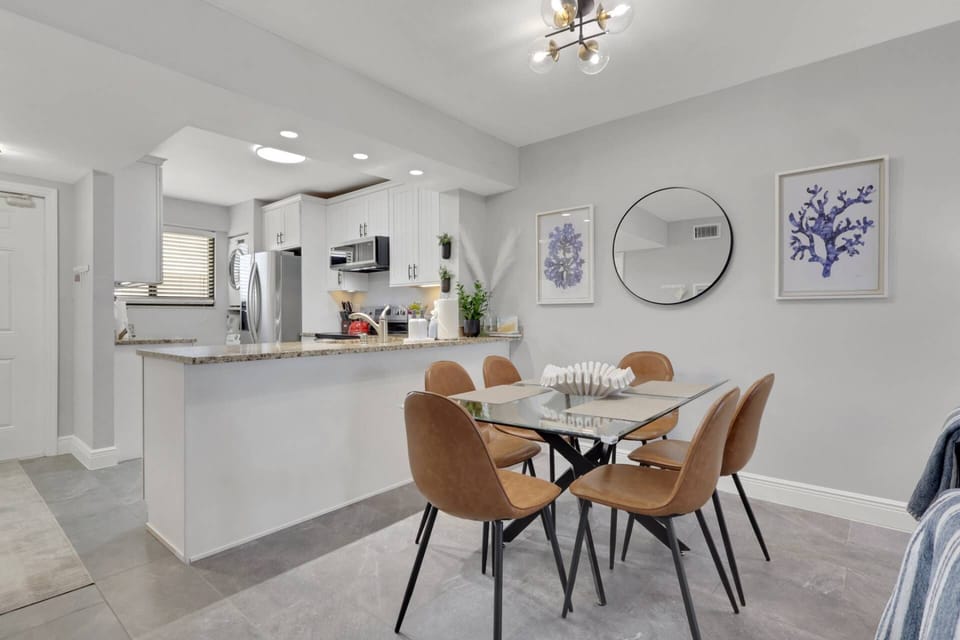 Open to the dining and living areas, the kitchen creates a welcoming space where family and friends can gather throughout the day.