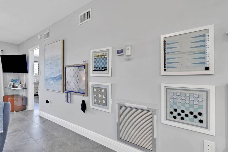 Rainy day? Family game night? This unique gallery wall transforms into hours of fun with games that double as coastal décor.