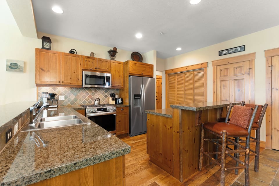 Your fully equipped kitchen invites you to whip up meals with stainless steel appliances, granite countertops, and a cozy breakfast bar perfect for casual dining and morning coffee.
