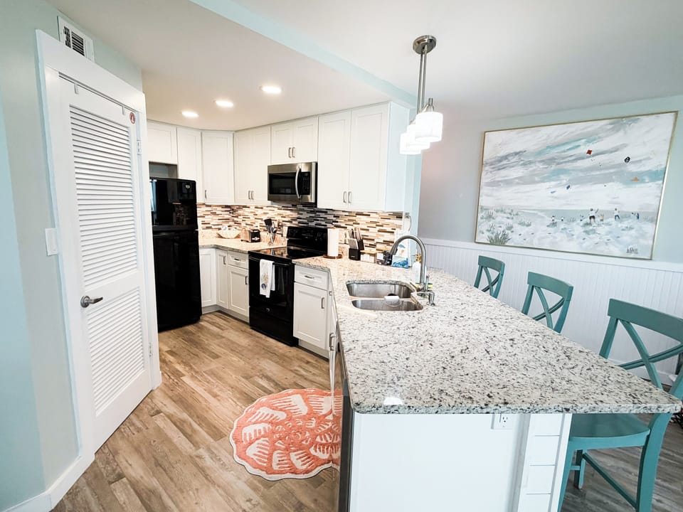 Fully equipped kitchen with granite counters and bar seating