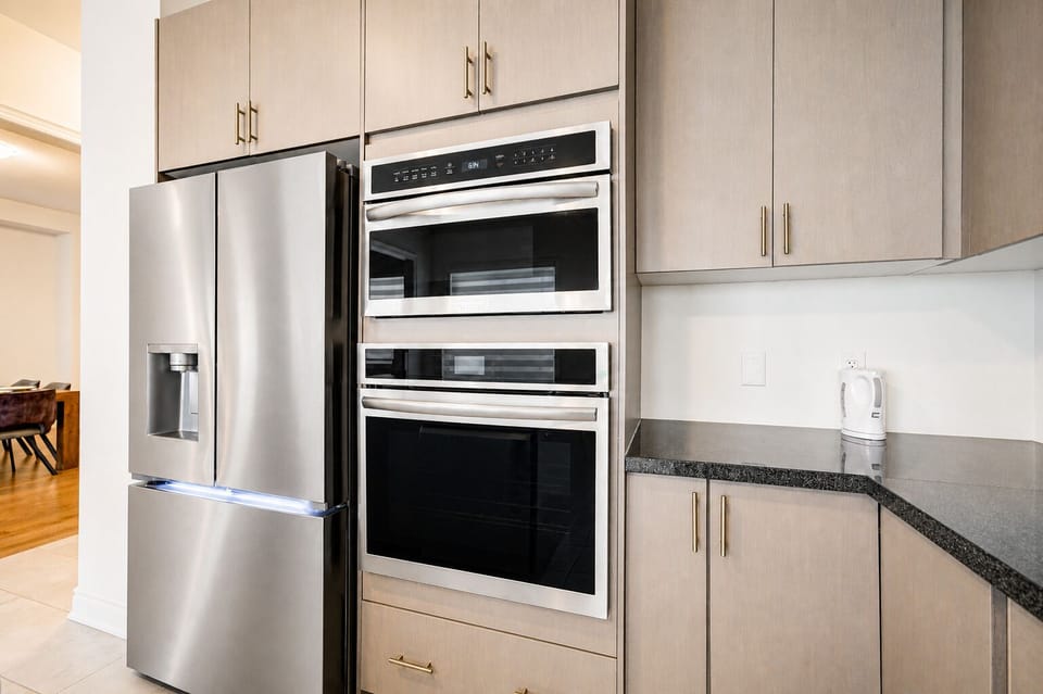 Modern kitchen with double ovens, stainless appliances, and ample storage