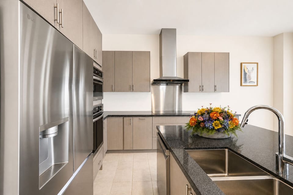 Bright modern kitchen with stainless appliances and stylish island