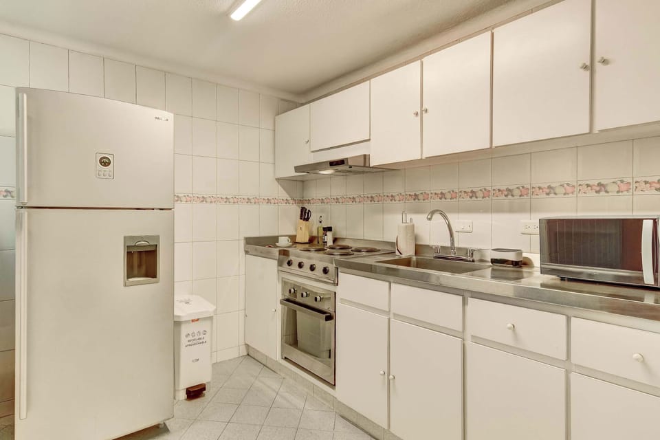 Fully equipped kitchen with ample storage, modern appliances, and everything needed to prepare meals during your stay.