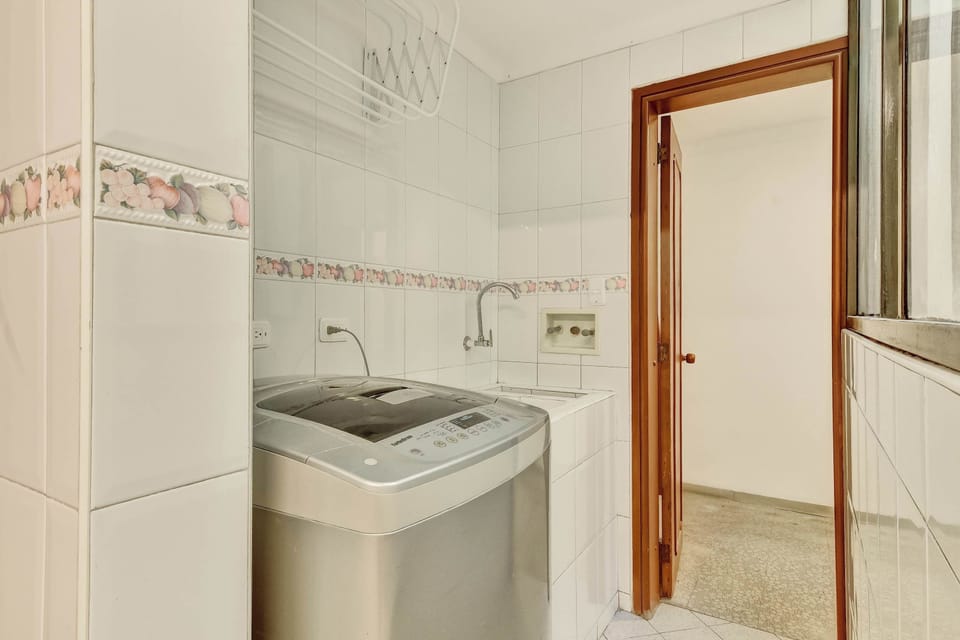 Convenient laundry area with washer and utility sink, making longer stays even more comfortable.