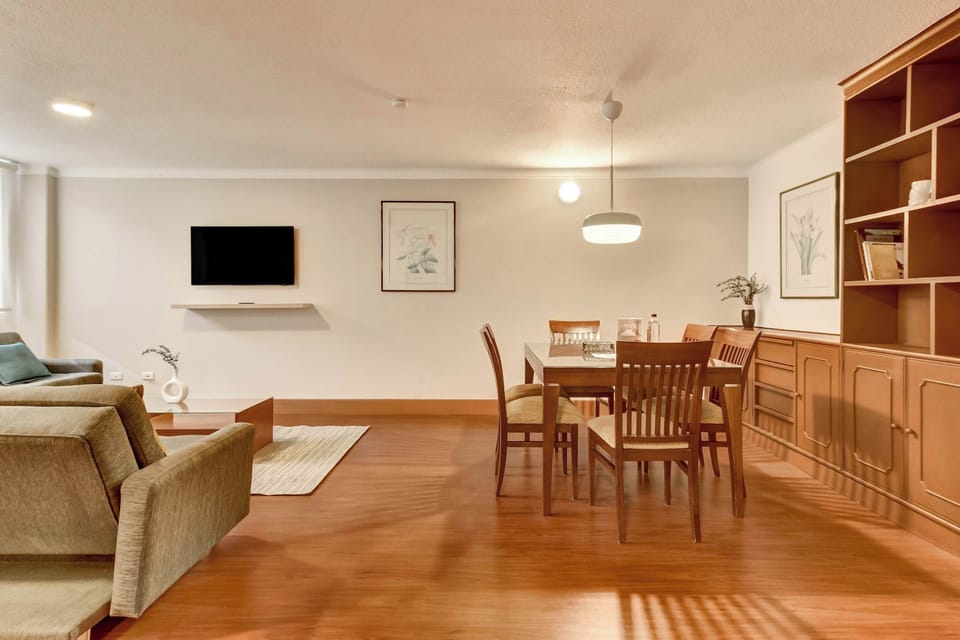 Open-concept living and dining space designed for comfort, featuring elegant furnishings and a warm atmosphere.