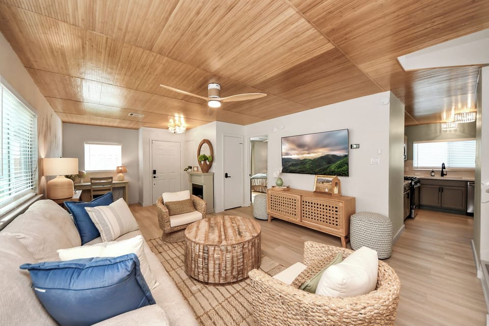 Unwind on the plush sofa, enjoy conversation in the custom woven armchairs, or stream your favorite shows on the large smart TV. 