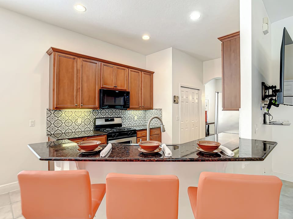 Kitchen Paradise: Modern design with stylish bar seating, perfect for family meals and fun!