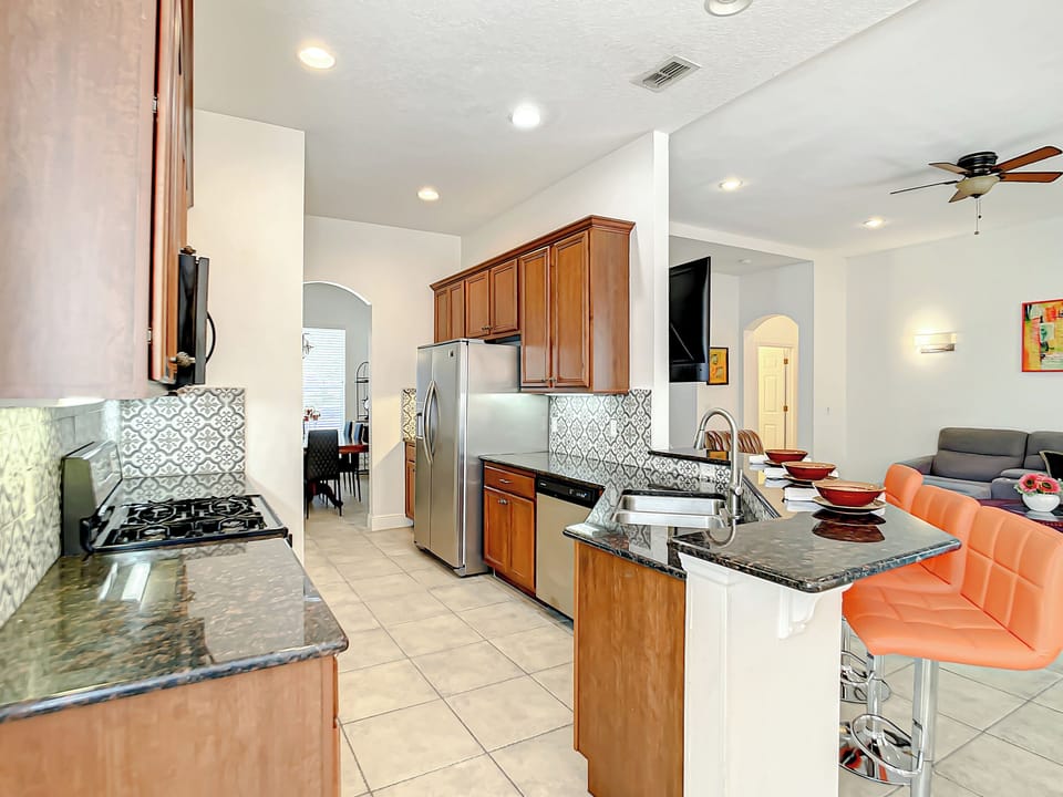 Kitchen & Living Area: Bright space with sleek counters, modern appliances, and vibrant decor!
