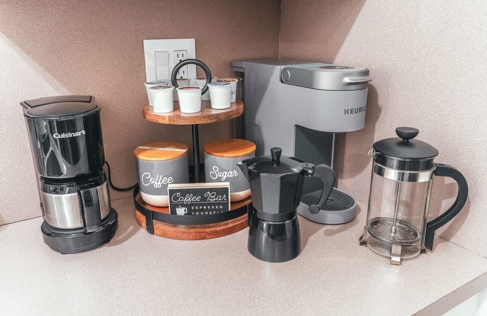 Fully equipped coffee station, an assortment of coffees, teas, & mugs 