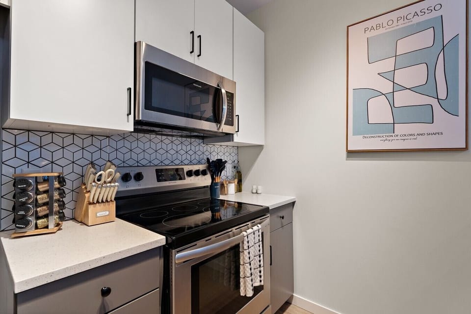 Modern kitchen with stainless steel appliances, stylish backsplash, and all the essentials needed for easy meal prep.