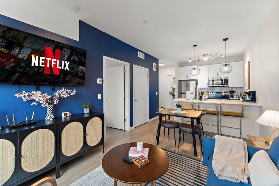 Open-concept living and dining area with a Smart TV, stylish decor, and a comfortable setup for relaxing.