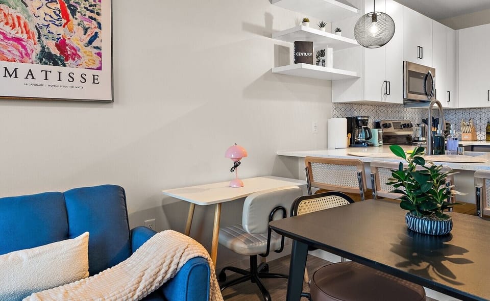 Charming dining nook with modern decor, colorful accents, and an open view of the kitchen and living space.