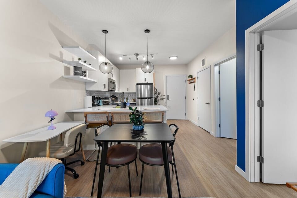 Open-concept dining and kitchen area with modern finishes, plenty of seating, and a bright, welcoming layout.