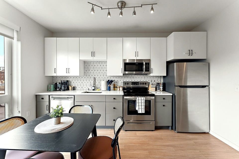 Prepare meals with ease in a clean, modern kitchen featuring full-size appliances and plenty of essentials.