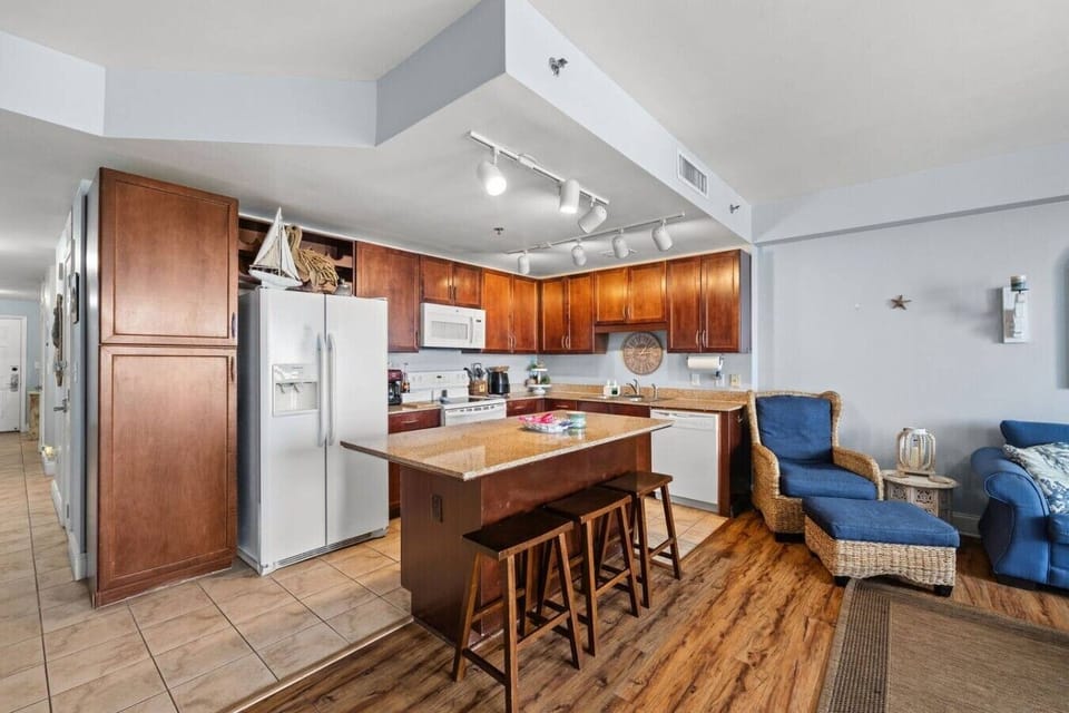Enjoy an open and airy beach retreat with a large kitchen island, coastal décor, and plenty of room to unwind.