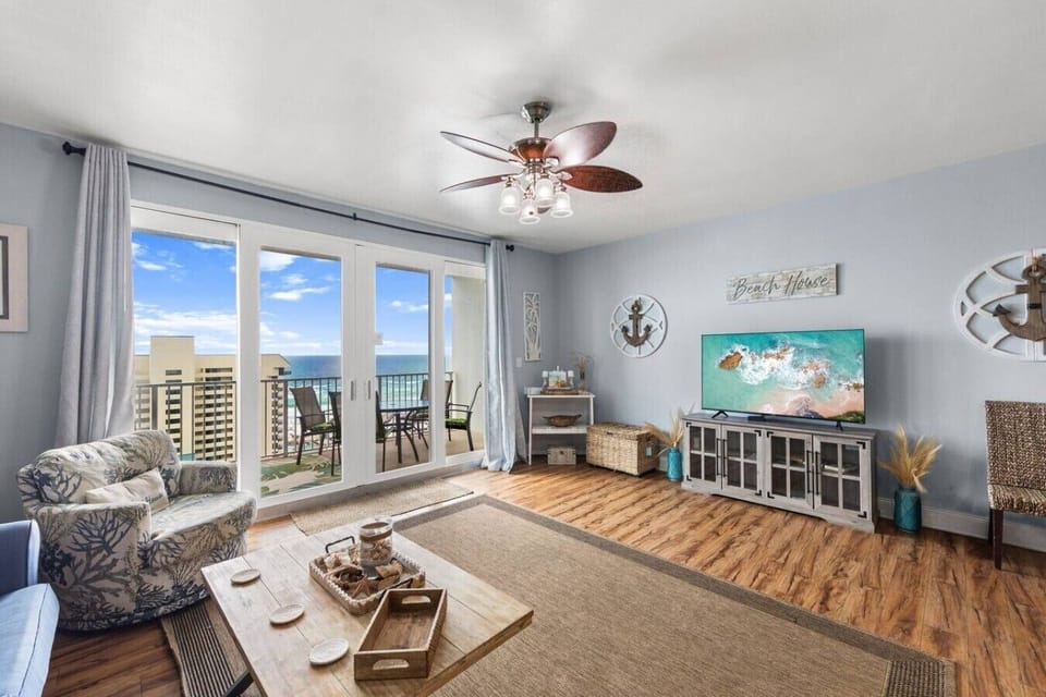 Relax in the bright coastal living room with comfortable seating and direct access to the private Gulf-view balcony.