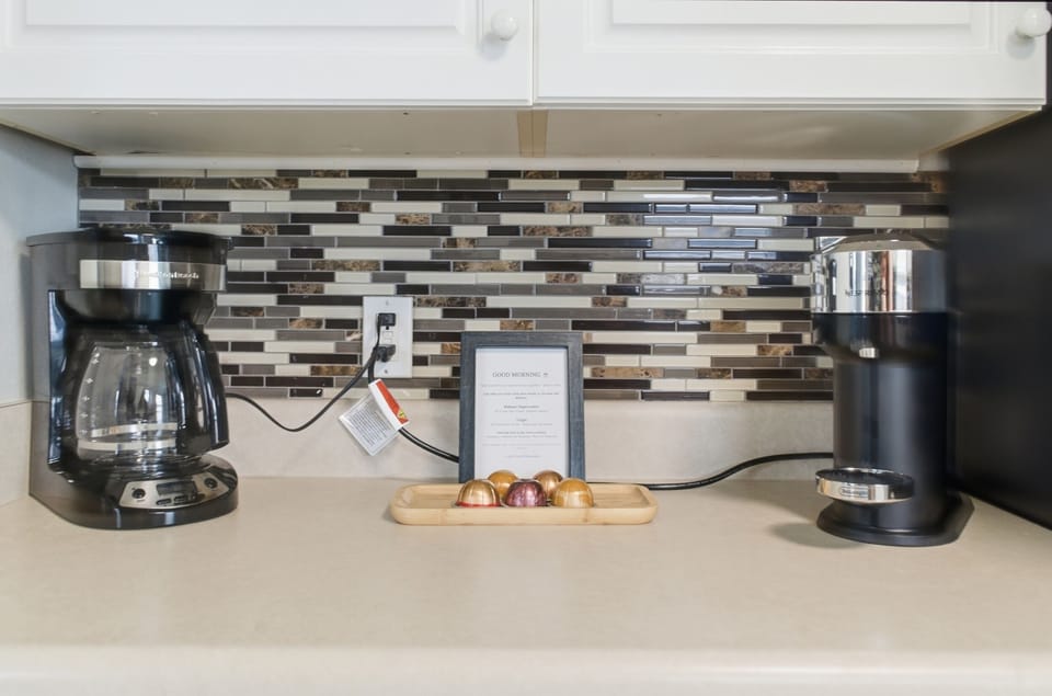  kitchen with coffee station, dishwasher, and full cookware"
