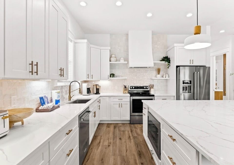 1st Floor - Fully stocked gourmet chef’s kitchen with stainless steel appliances, spacious island seating, and everything needed to prepare meals for large groups. The perfect gathering place for cooking, dining, and making vacation memories together.