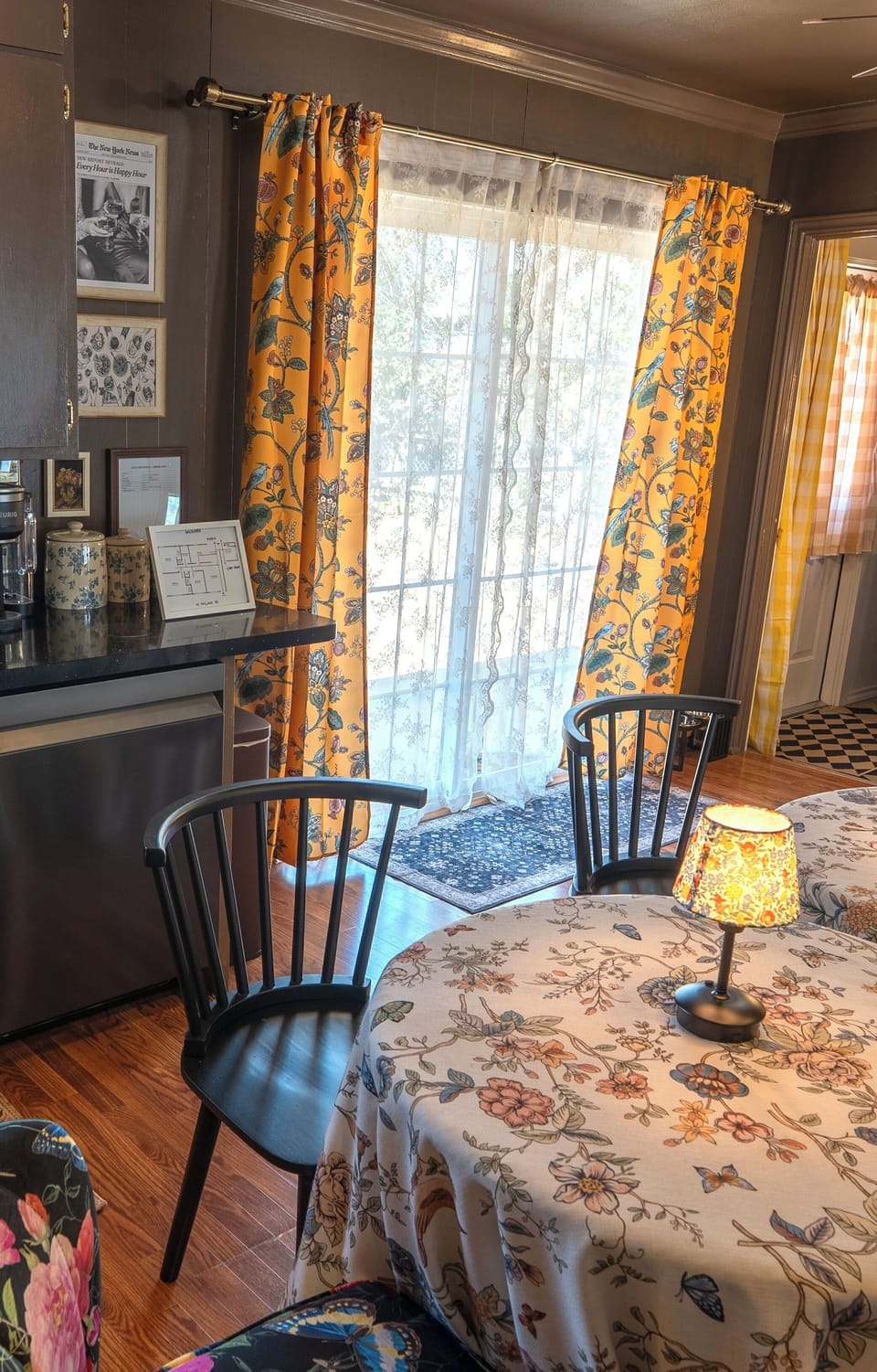 Sunny cottage-style dining nook with floral decor and patio door light
