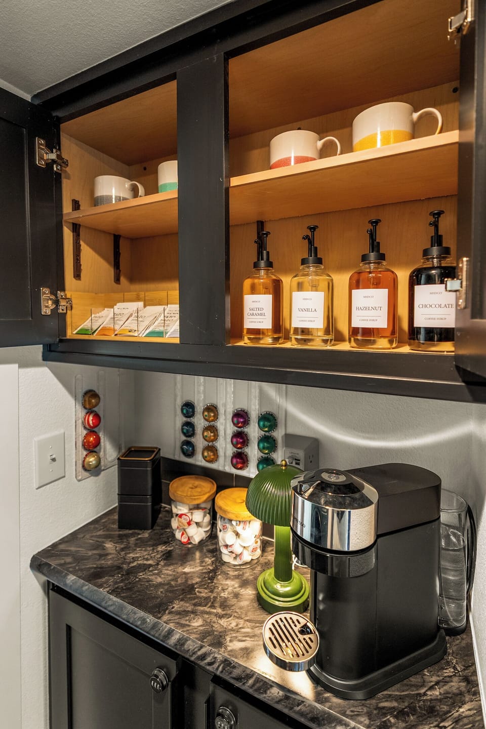 Build your own coffee order before the hike — flavored syrups, a rotating tea drawer, and a machine that does the rest.
