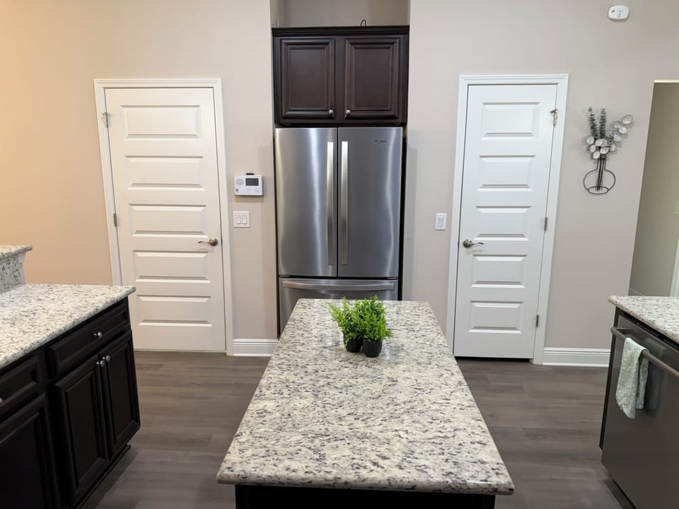 Modern kitchen with granite island and stainless steel appliances