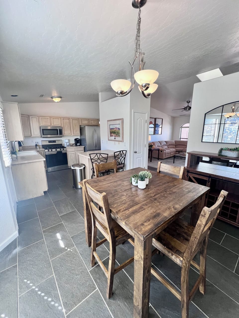 The spacious kitchen boasts ample counter space, stainless steel appliances, and all the essentials you need to whip up a gourmet meal with ease.