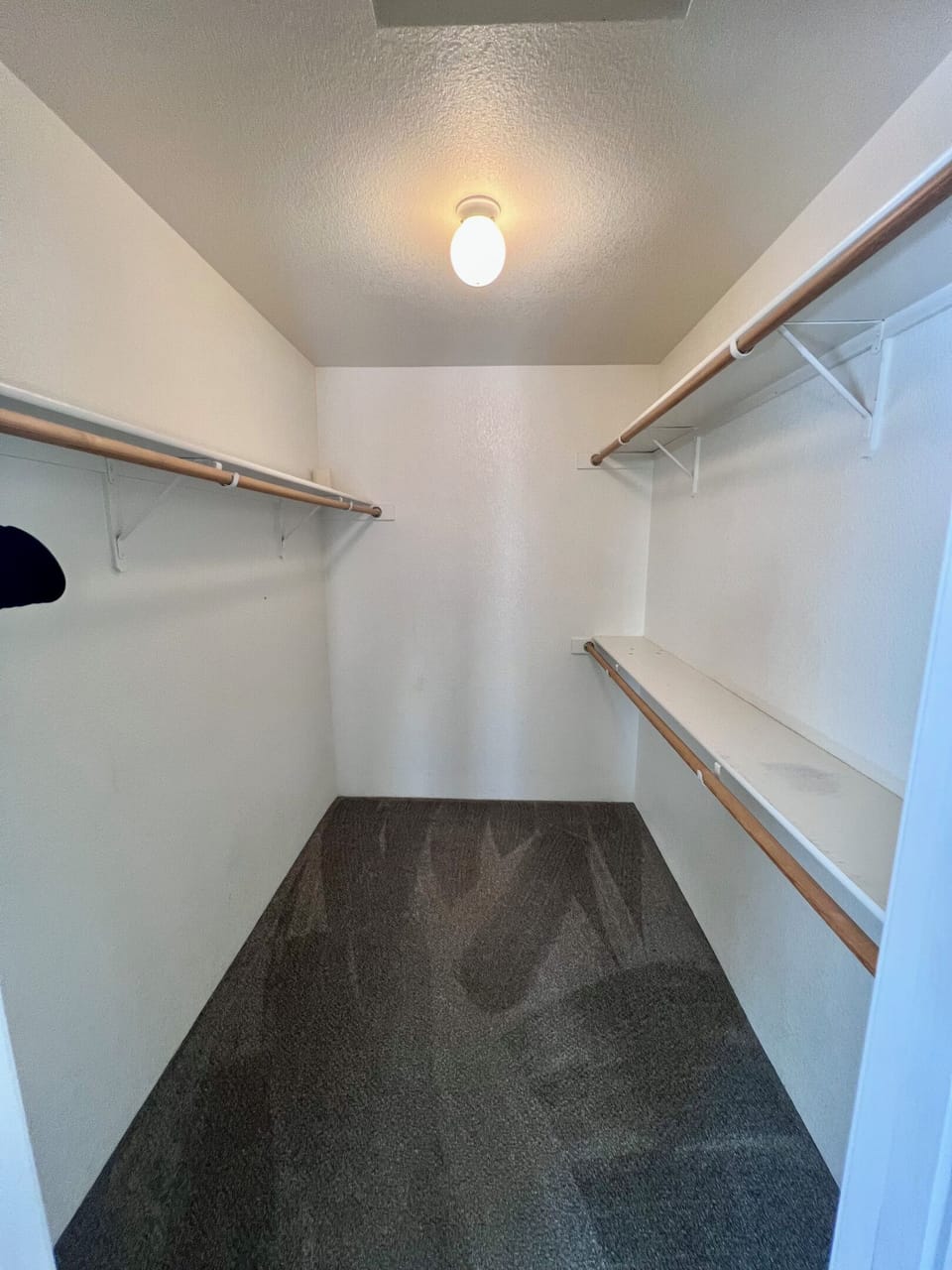 The spacious walk-in closet offers ample hanging space and convenient shelving to keep your belongings organized throughout your stay.