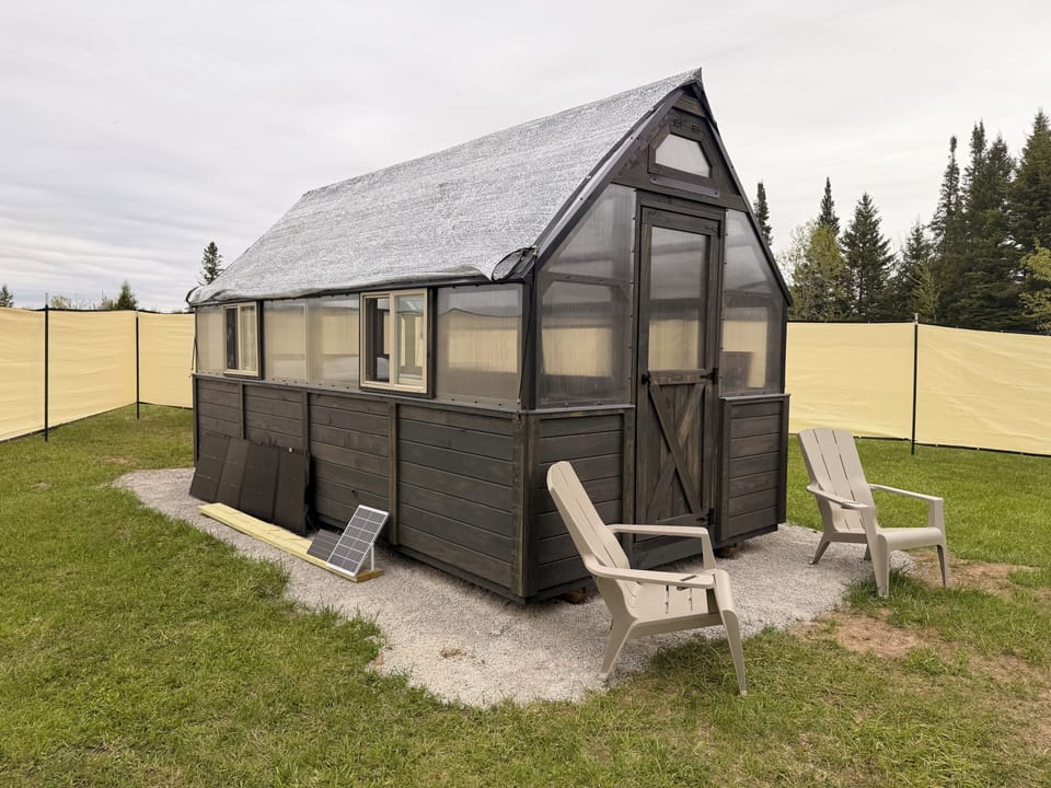 Cozy A-frame glamping cabin with outdoor seating and peaceful views