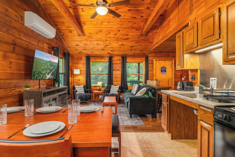 🍳 Open kitchen + dining with forest views in every direction.
