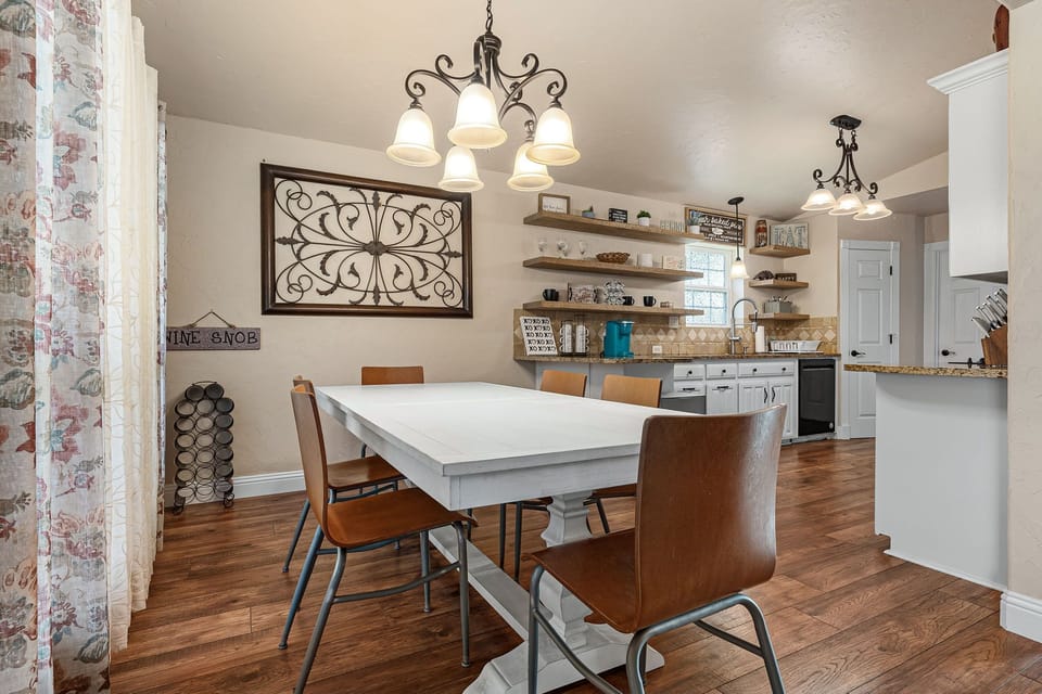 8 person dining table by open space kitchen and huge windows